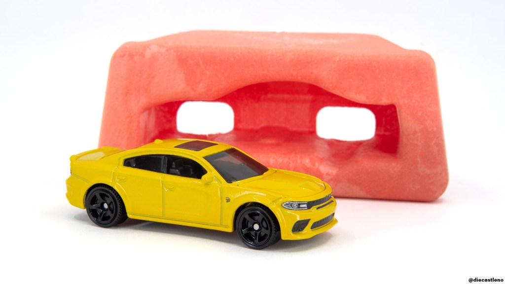 Matchbox Dodge Charger Hellcat Moving Parts model in front of its paperfoam package